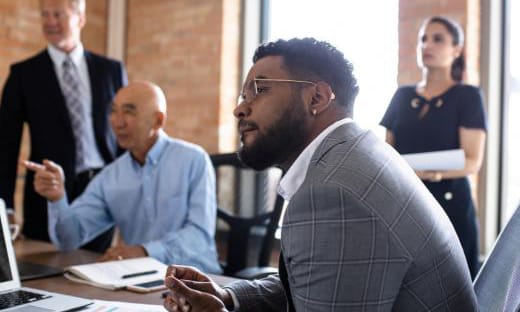 Senior executives in discussion around a boardroom table